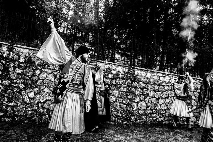 A dramatic moment during the blank-firing sequence at Agia Lavra.