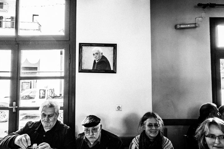 Local residents seated inside a village café in Eggares during Carnival.