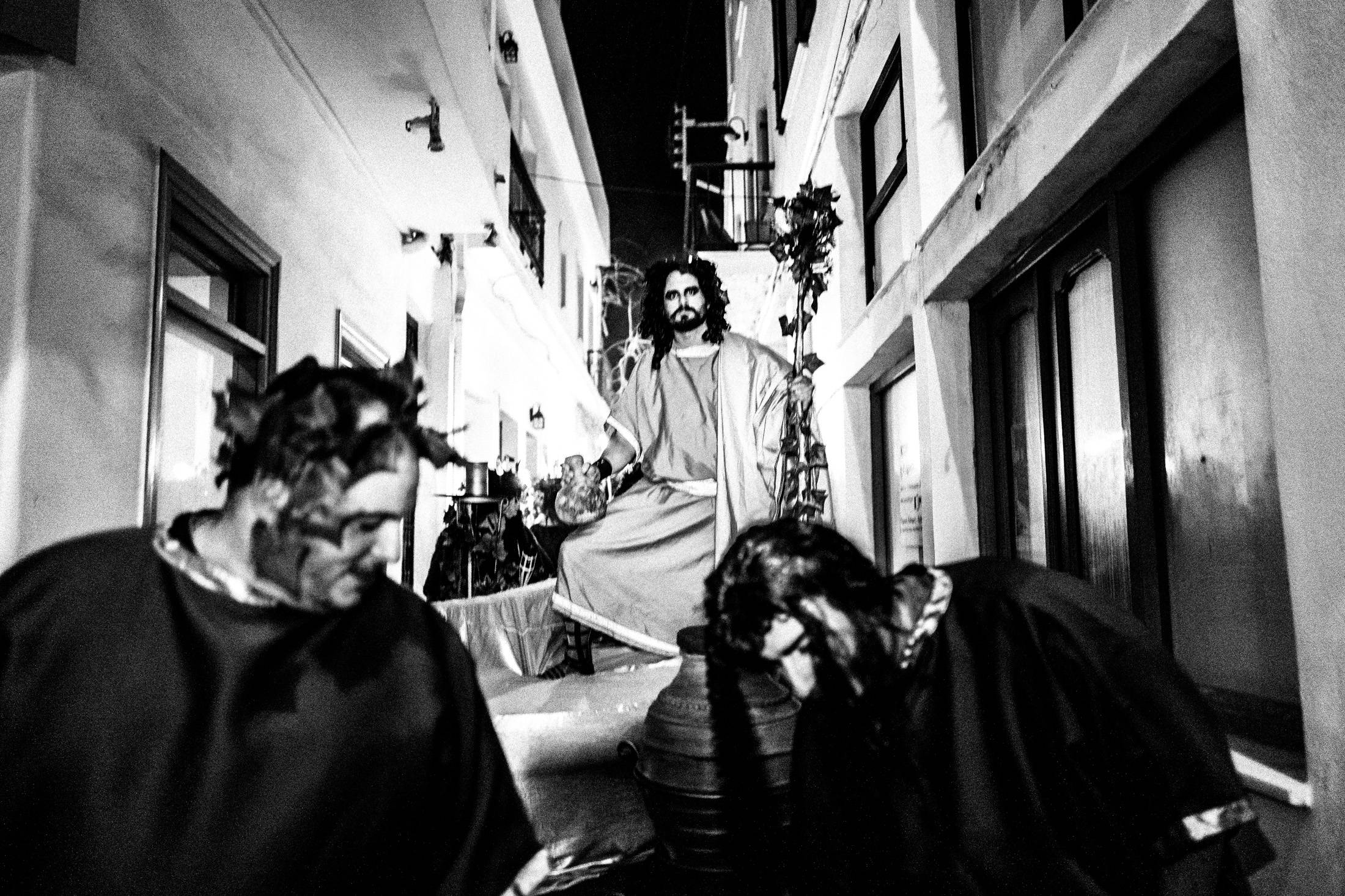 Dionysian Carnival performers dancing through the old town of Naxos.