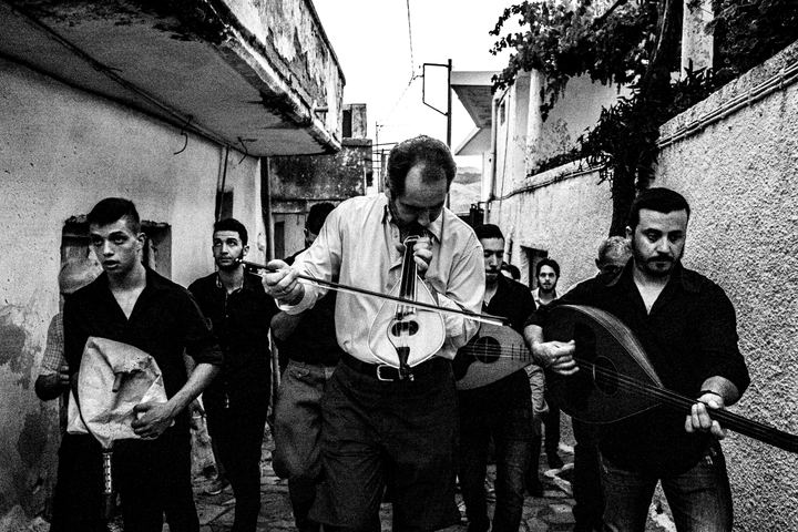 Cretan musicians walking through Spili during the annual Cantades.