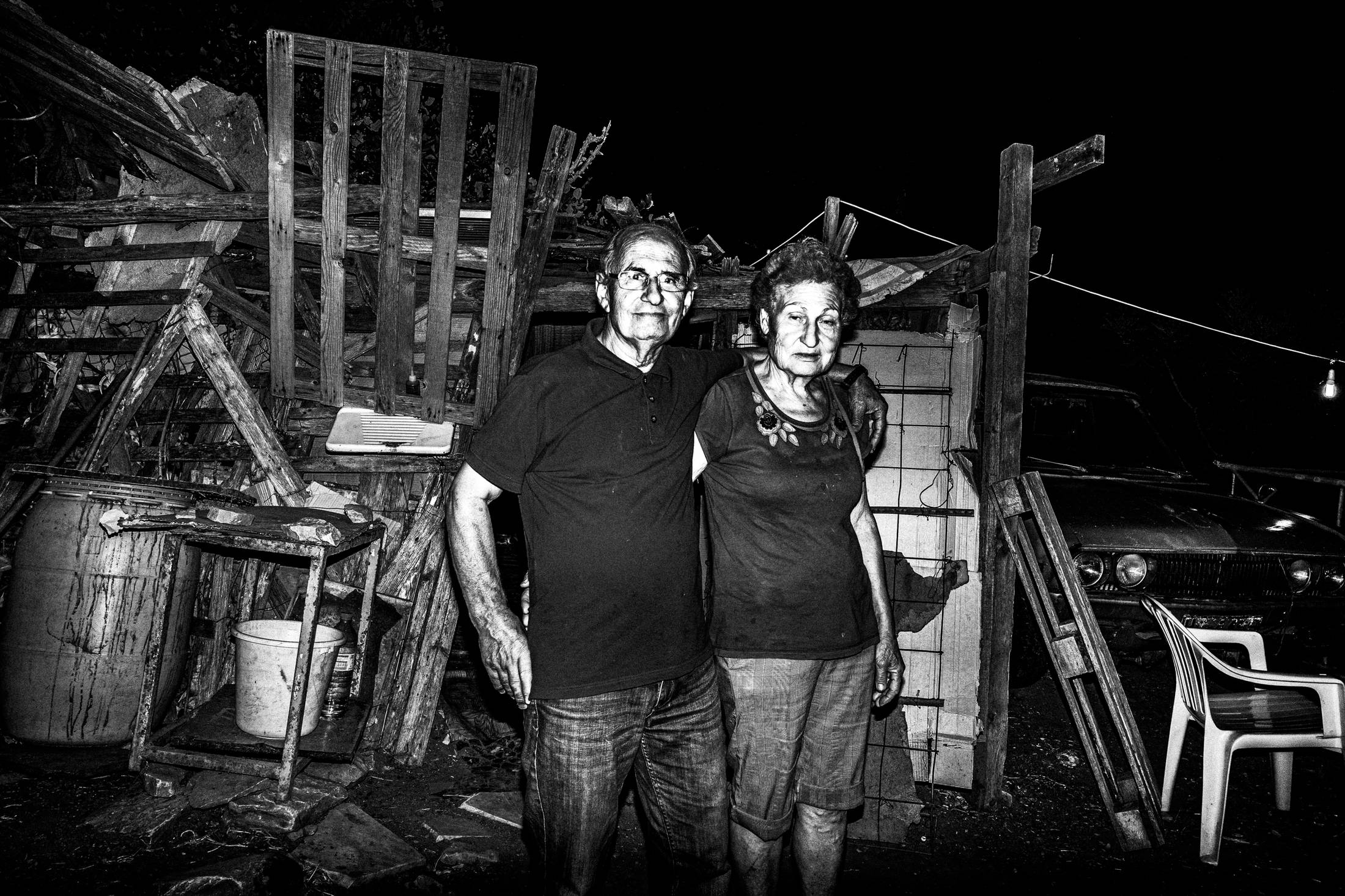 A pilgrim couple standing in front of their temporary hut.