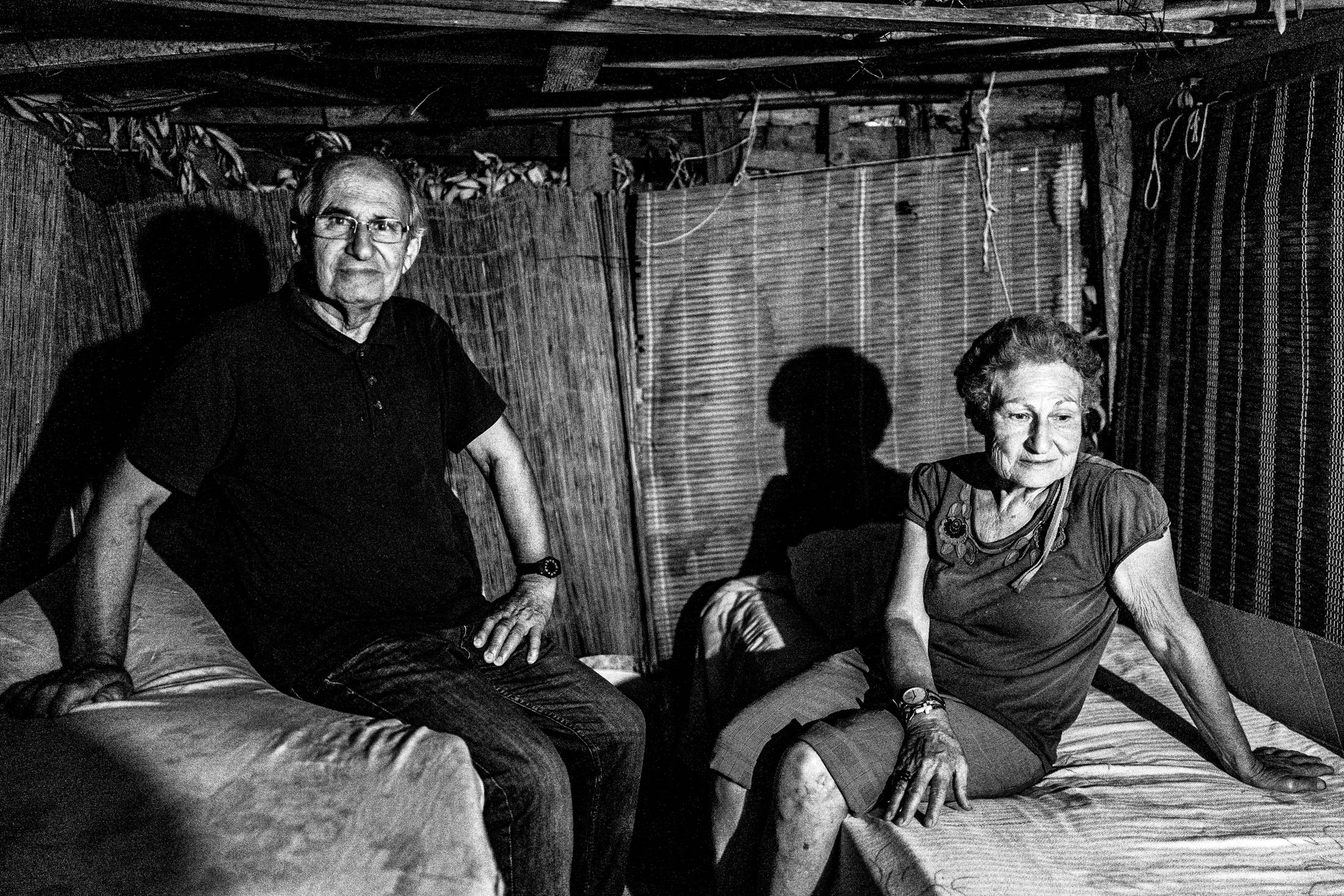 Pilgrims standing outside their hut after dark.