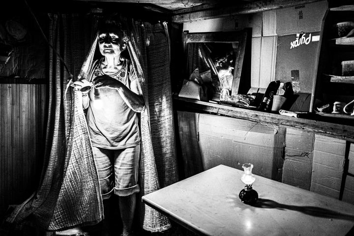 A woman inside an improvised hut during the Panagia Charakiani pilgrimage.