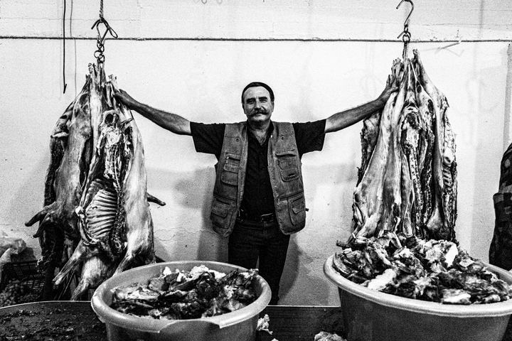 Prepared lamb hanging in the food area at the Saint Fanourios festival.