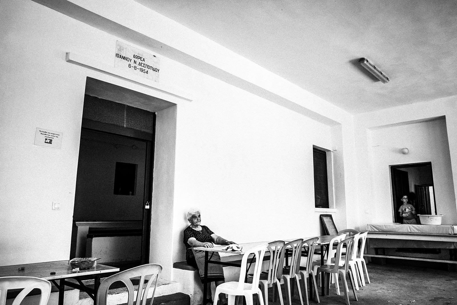 A woman sitting outside the galley of Agia Paraskevi on Amorgos