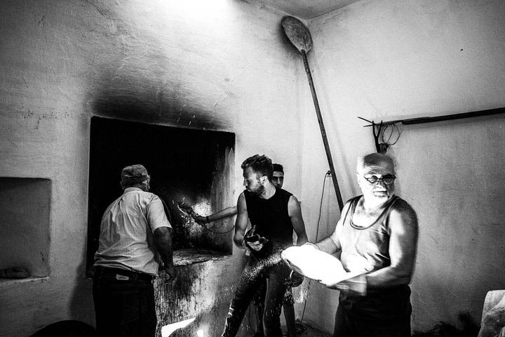 Volunteers baking in the wood-burning oven during the festival of Agia Paraskevi on Amorgos