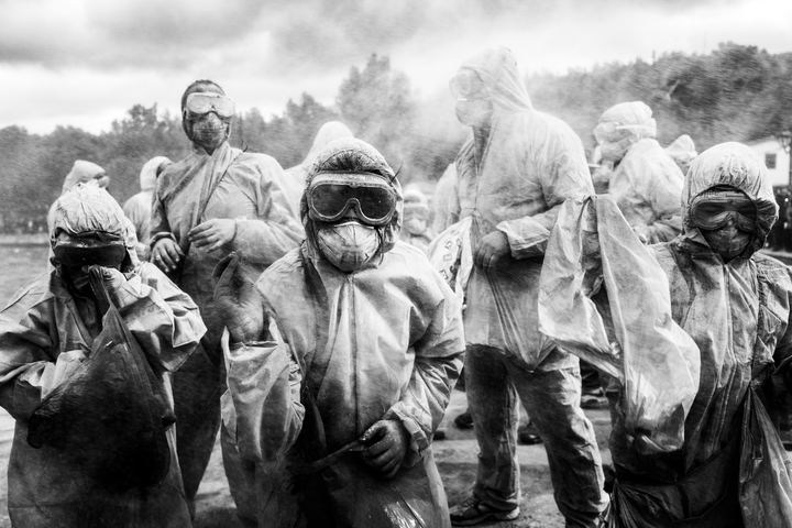 Flour-covered participants wearing protective clothes and masks at Alevromountzouromata in Galaxidi.