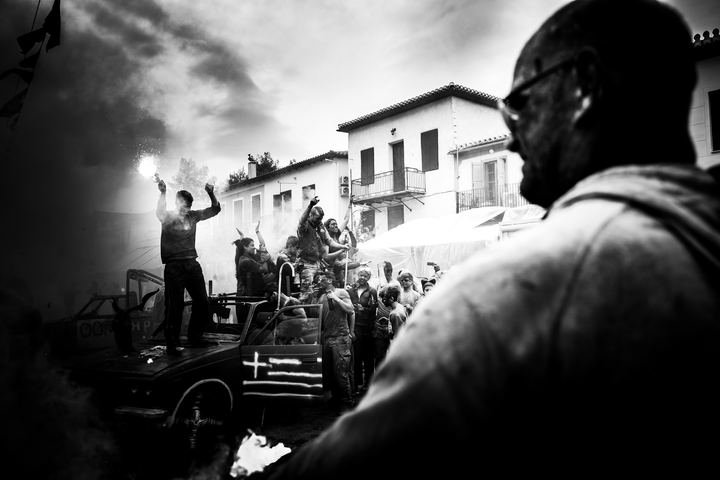 A flare burning above participants during Alevromountzouromata in Galaxidi.