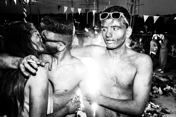 Three flour-covered participants standing together during the Galaxidi Flour Wars.