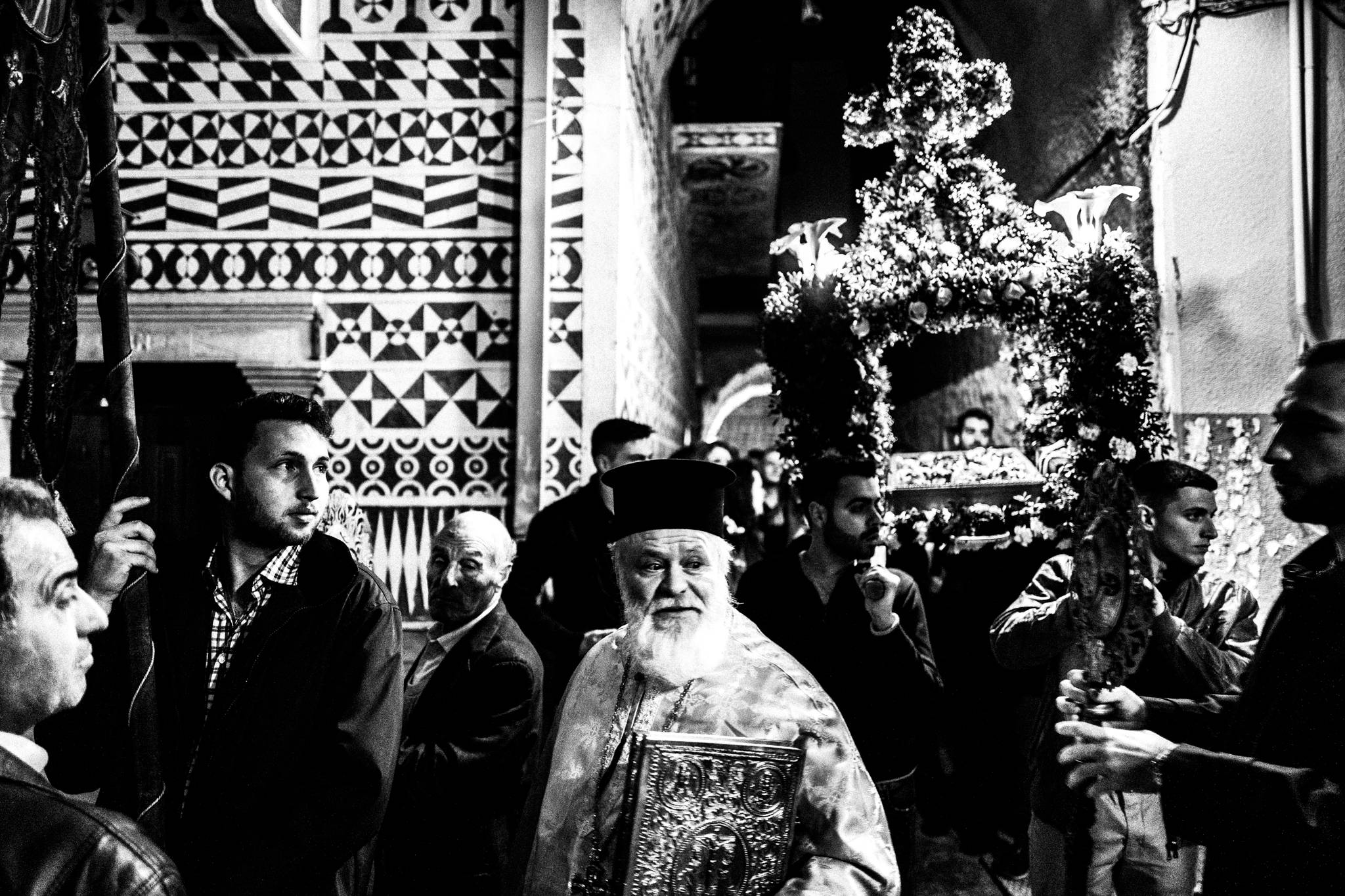Residents following the Epitaph procession through Pyrgi at night.
