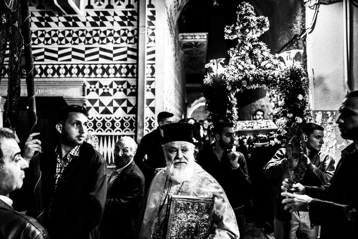 Residents following the Epitaph procession through Pyrgi at night.