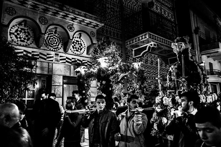 The Epitaph procession framed by the decorated buildings of Pyrgi.