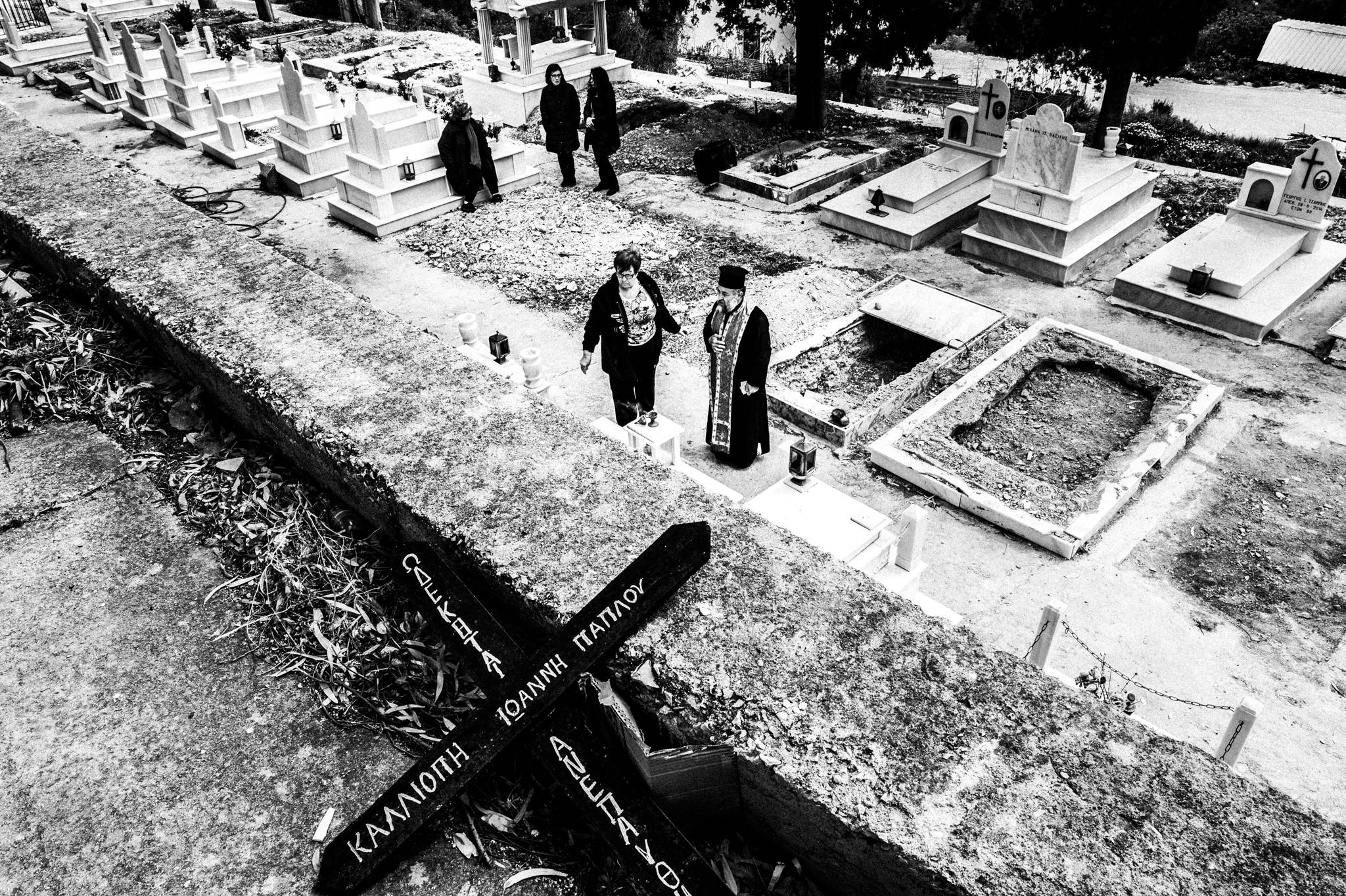 A woman among the graves during the Good Friday memorial in Pyrgi.