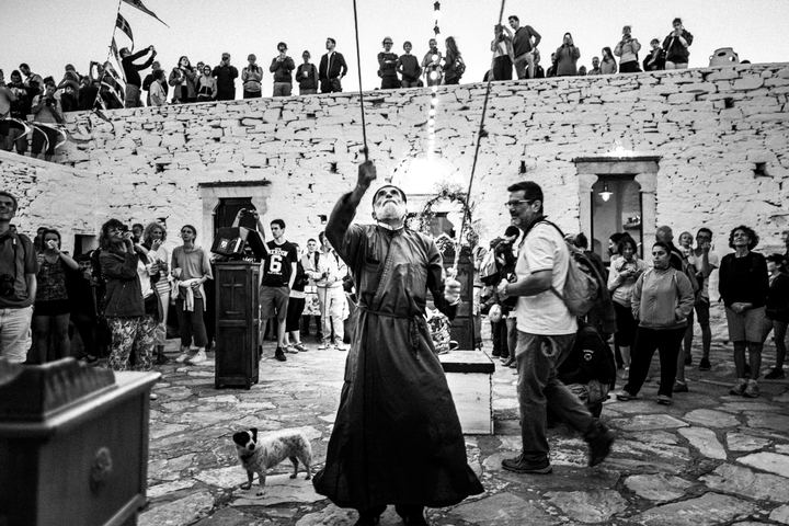 The priest ringing the monastery bells before the evening Mass.