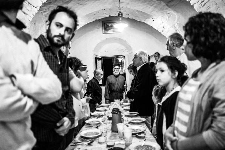 Pilgrims gathered around the monastery dining table before eating.