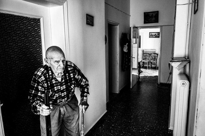 Nikolaos Drossos seated inside his home in Emporio.