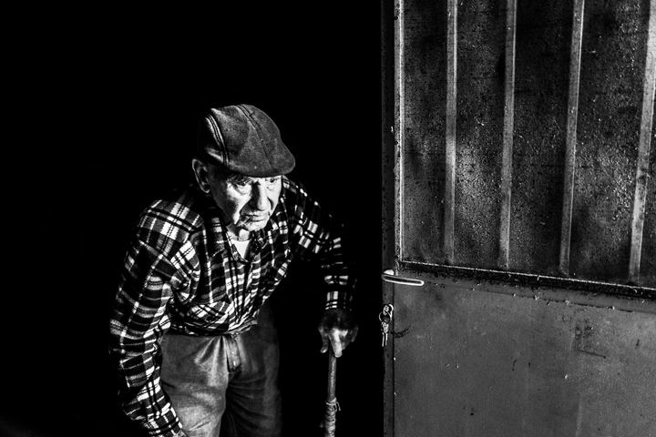 A traditional winemaker entering his wine cellar in Emporio.