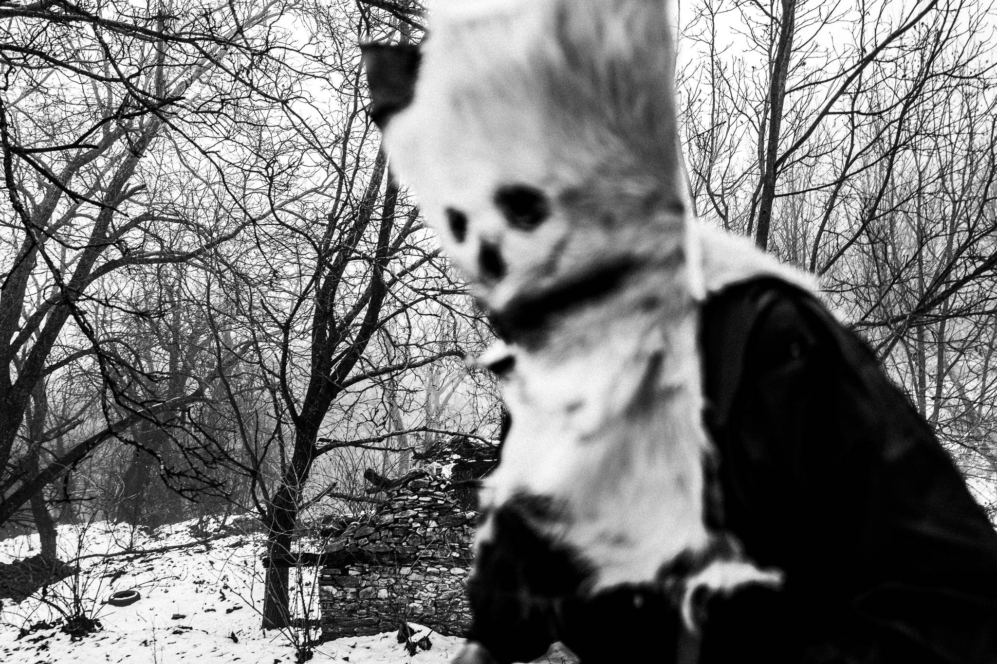 A scary bell-bearer in a snowy forest in Pagoneri, Drama.