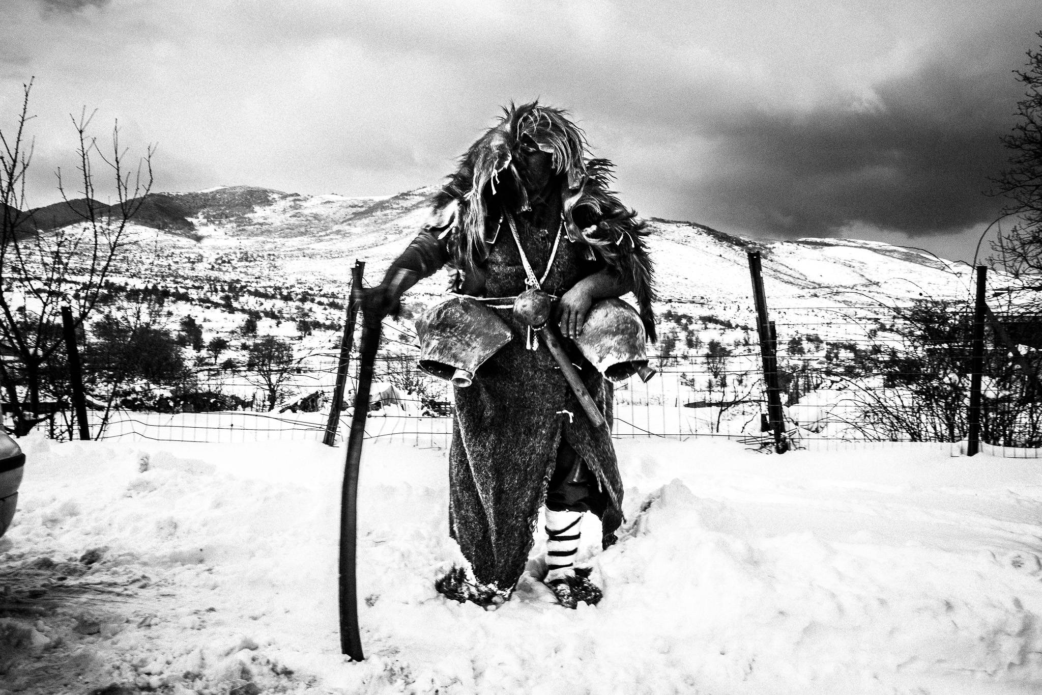 A bell-bearer in the snow in the village of Volakas, Drama