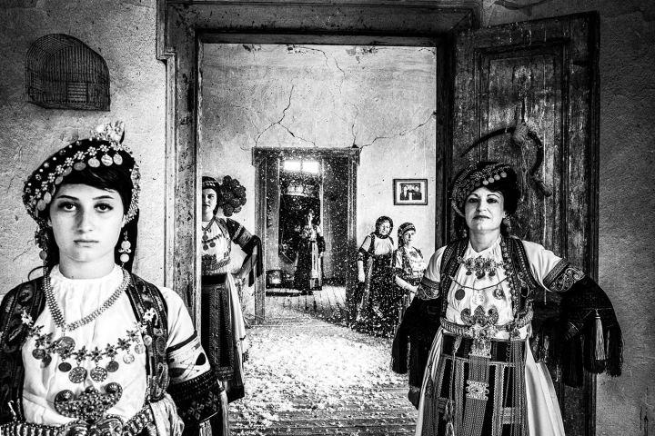 Six women wearing the costumes of Karagouna inside an old local Mansion in Glinos, Trikala