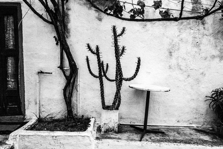 Black and white photograph of a narrow alley in Megisti, Kastellorizo.