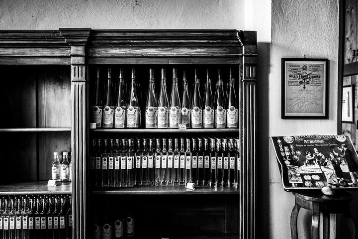 Black and white photograph of Kitron Naxou bottles displayed inside the distillery.