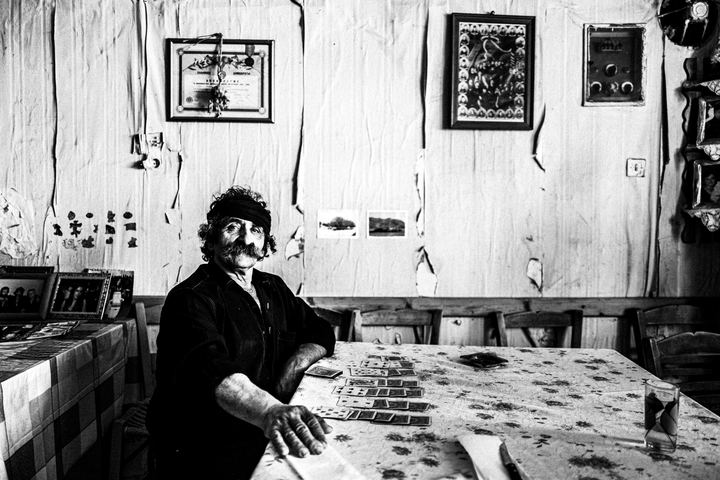 Black and white portrait of Lefteris inside his café in Anogia, Crete.
