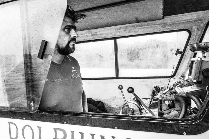 Black and white portrait of Pavlos on his fishing boat near Diafani, Karpathos.