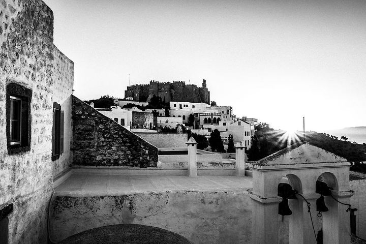 Black and white photograph of the view from the house of Vassilis Kypraios toward the monastery and Aegean light in Patmos.