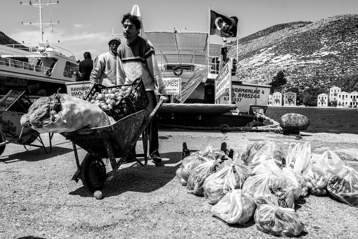Black and white photograph of supplies arriving in Kastellorizo from the nearby Turkish town of Kaş.