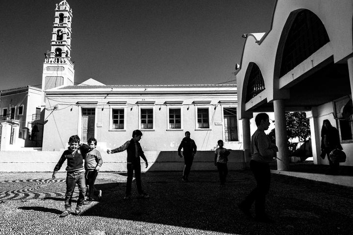 Black and white photograph of children playing in a yard in Megisti, Kastellorizo.