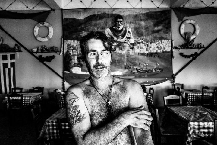 A close-up portrait of Nikitas, a tavern owner, at his place on the island of Kalymnos