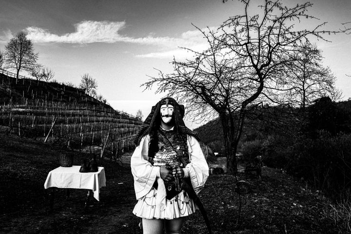 A man dressed as Genitsaros during the annual carnival custom, posing at a local vineyard of Xinomavro