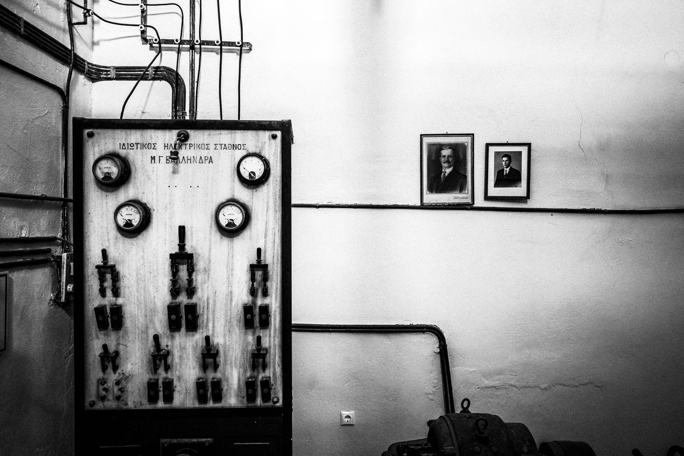 Black and white photograph of old electrical panels inside the Kitro distillery in Naxos.