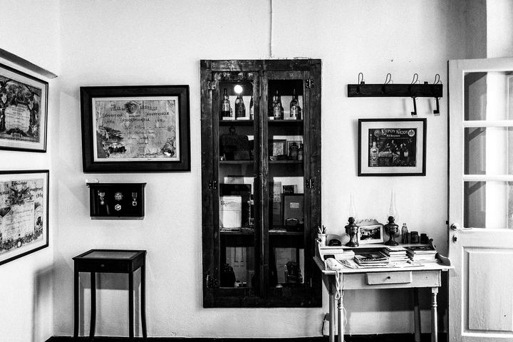 Black and white photograph of the interior of the Kitron Naxou distillery.
