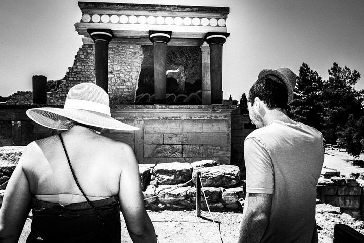 Black and white photograph of tourists visiting Knossos in Heraklion, Crete.