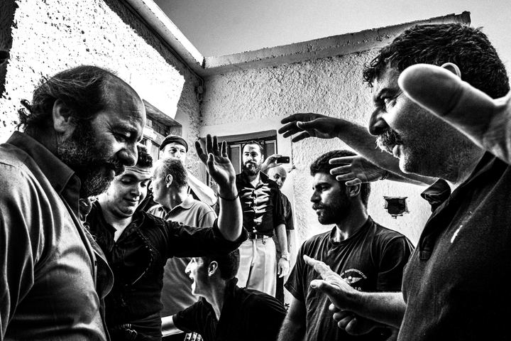 Black and white photograph of the ritual 'fight' at the bride's house during a wedding in Anogia, Crete.