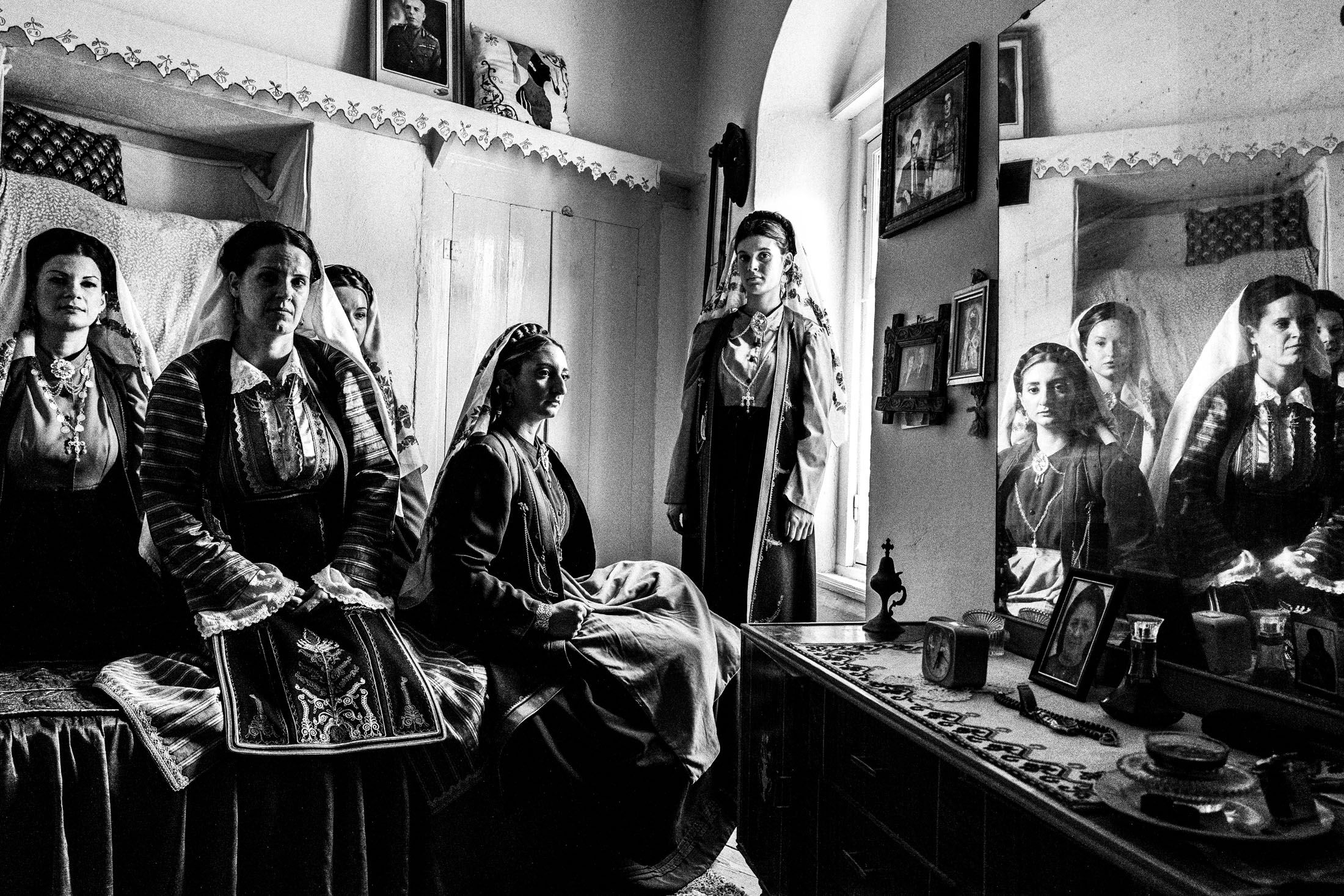 Women wearing the local dresses of Platanos, Nafpaktia, inside a local house