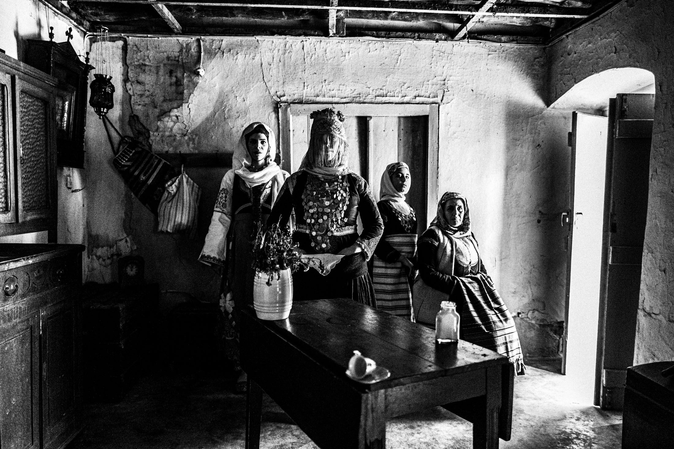 A group of women wearing the costumes of Megara, Attica, inside an old local house