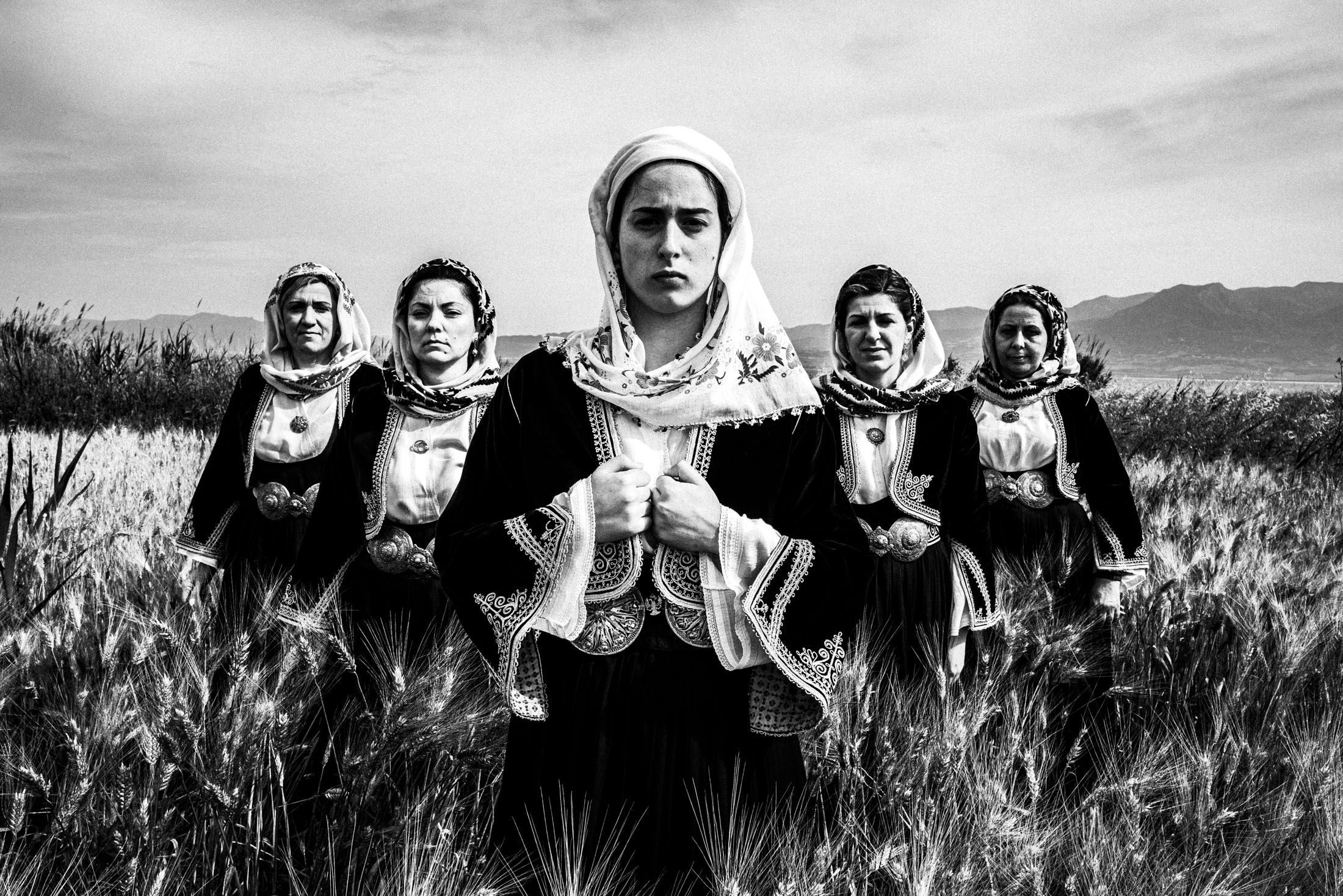 Women wearing the costume of Kymi, Euboea, standing in a local field
