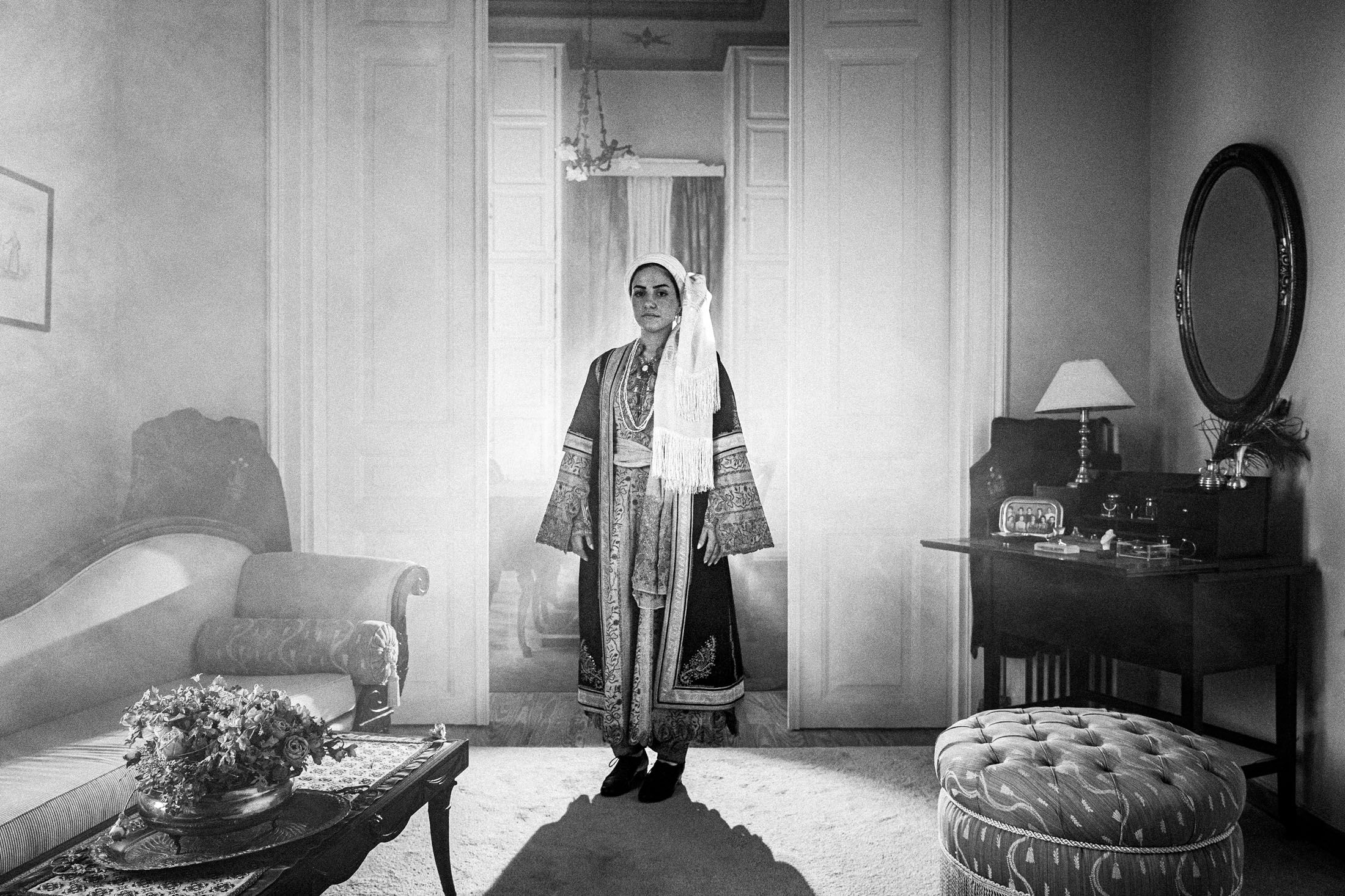 A woman wearing the local urban costumes of Kalamata, standing inside the Lyceum Club of Greek Women Kalamata
