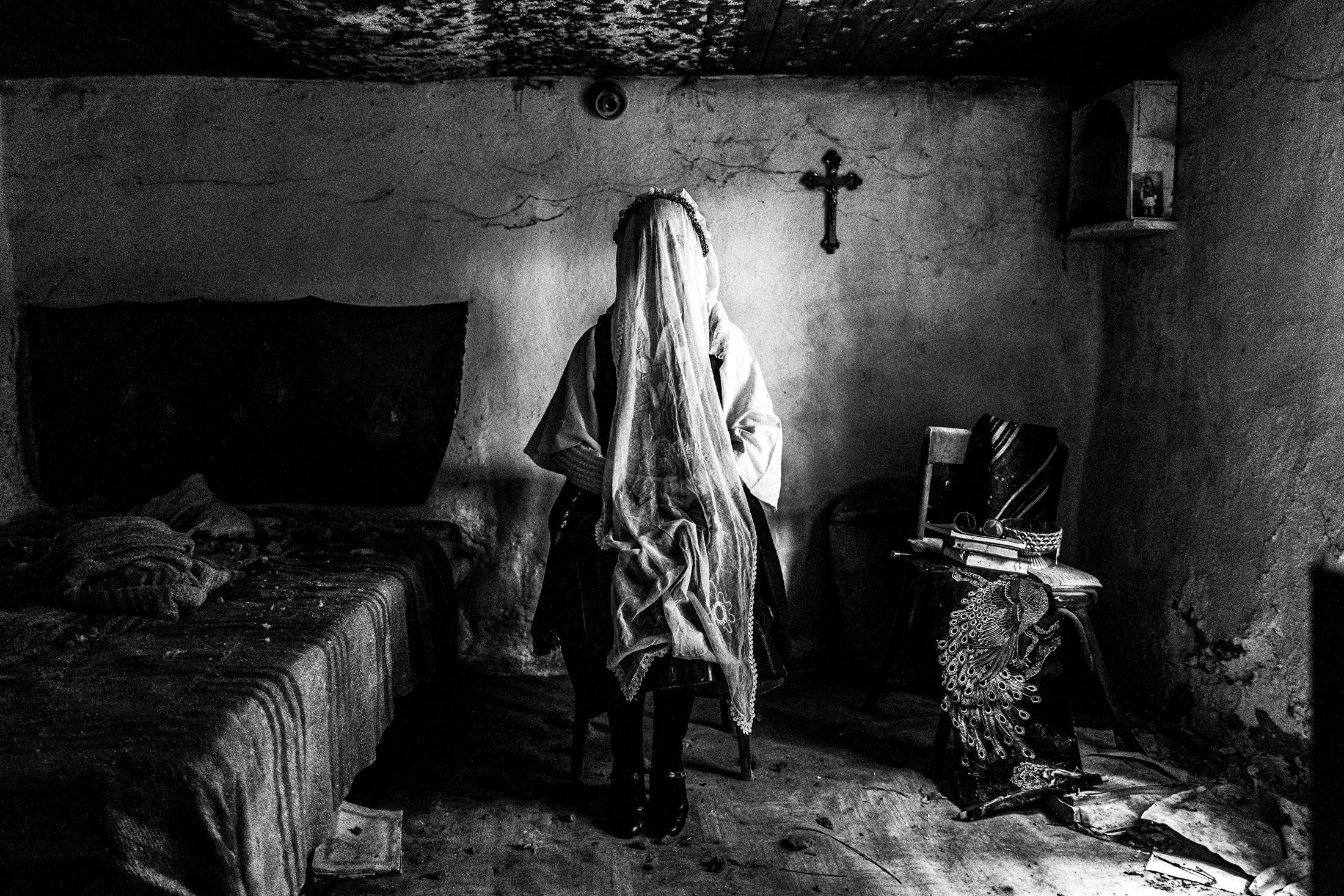 A veiled woman wearing the costume of Ermakia in an old abandoned local house