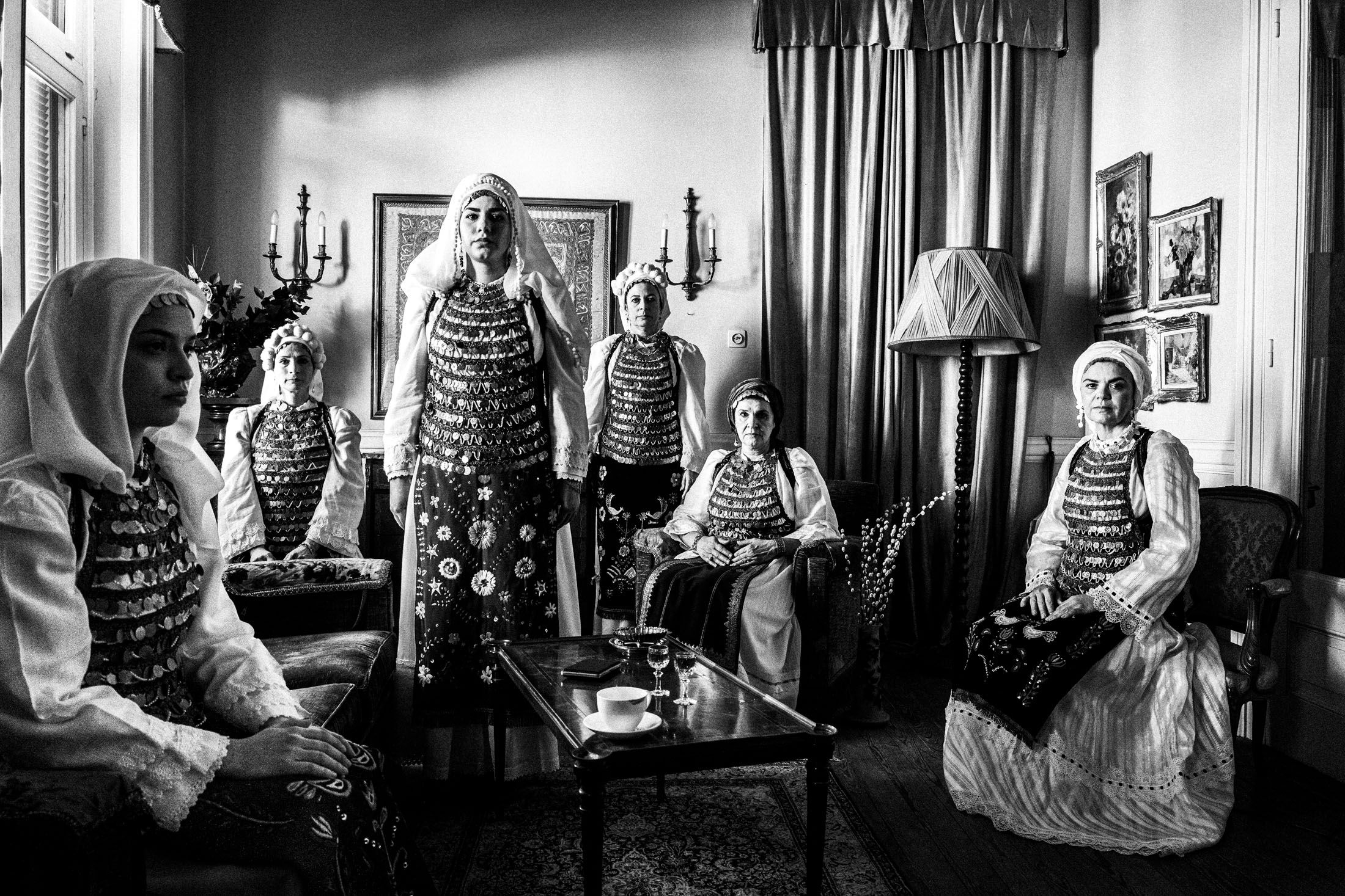 A group of women wearing the costume of Atalanti, inside a local house