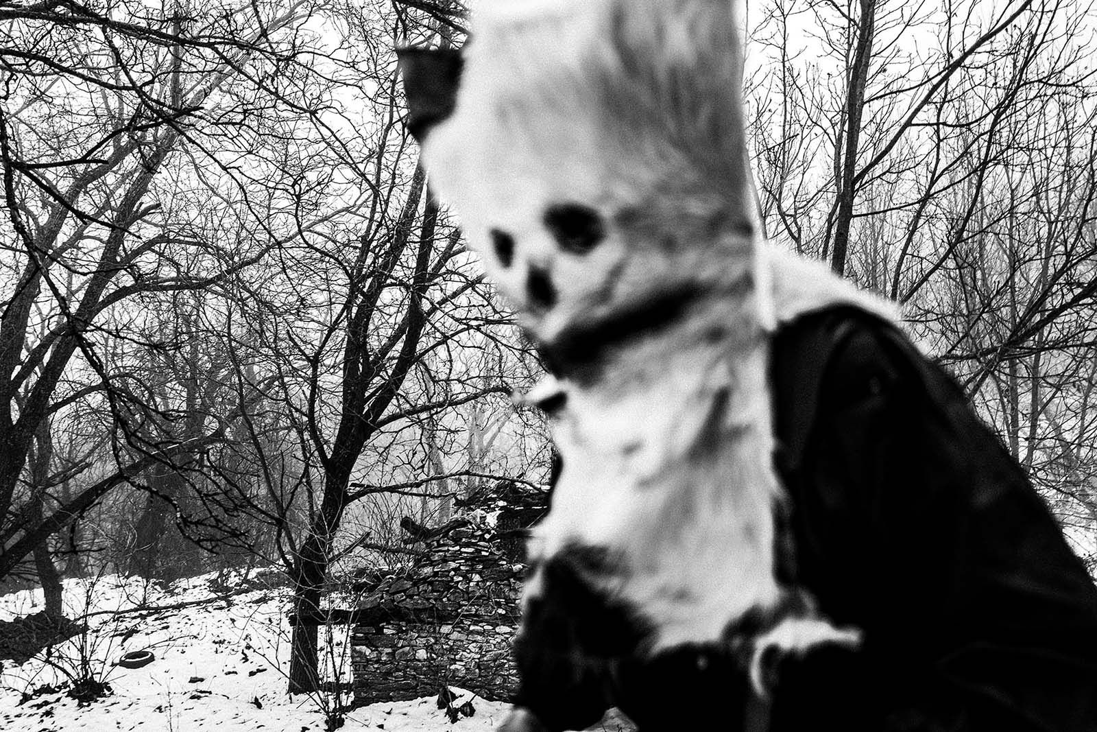 A scary bell-bearer in a snowy forest in Pagoneri, Drama.