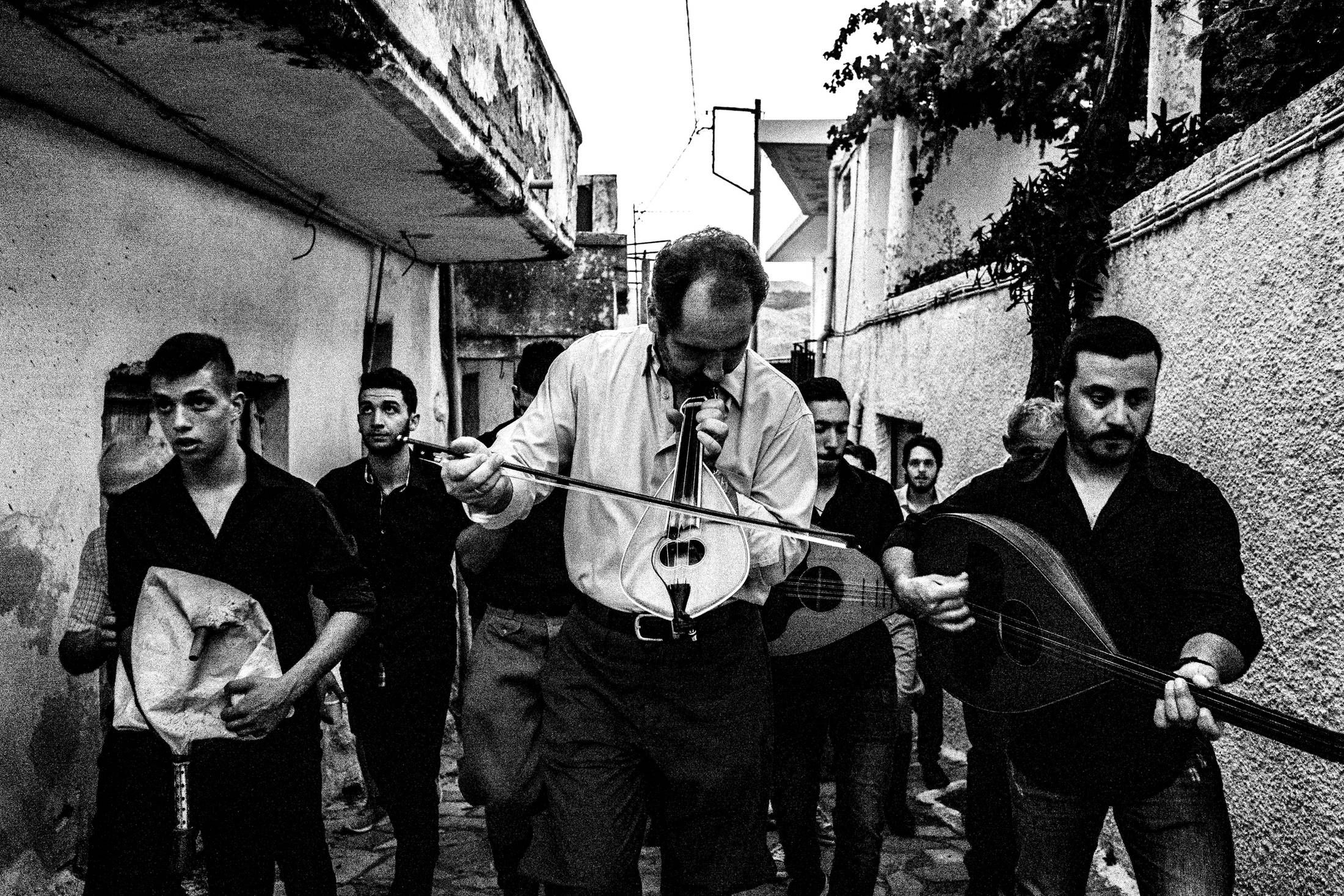 Cretan musicians walking through Spili during the annual Cantades.